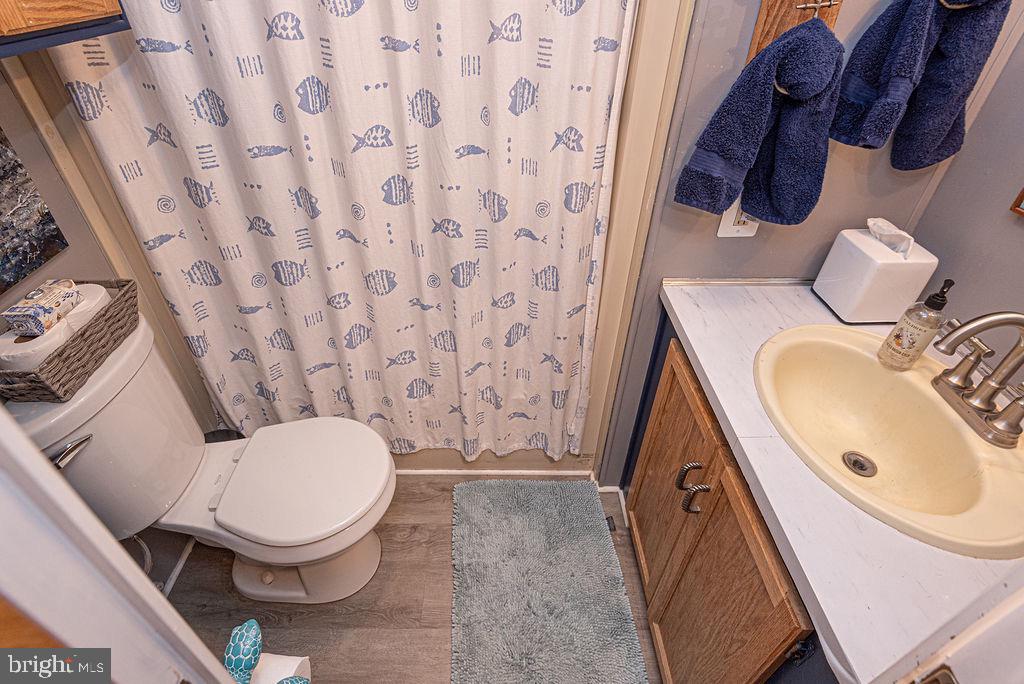 114 Skipjack Circle Berlin, MD 21811 - Photo 35 of 51 a bathroom with a granite countertop toilet sink and mirror
