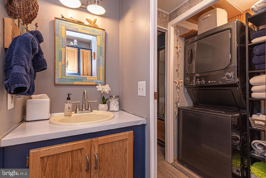 114 Skipjack Circle Berlin, MD 21811 - Photo 36 of 51 a bathroom with a sink a mirror and cabinets