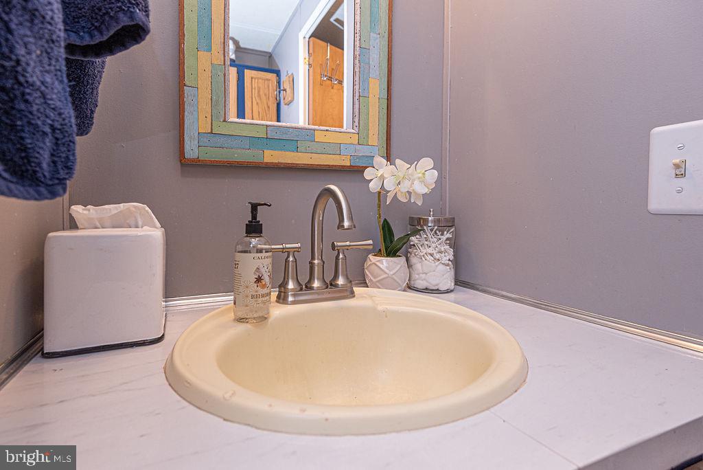 114 Skipjack Circle Berlin, MD 21811 - Photo 37 of 51 a bathroom with a sink and a mirror