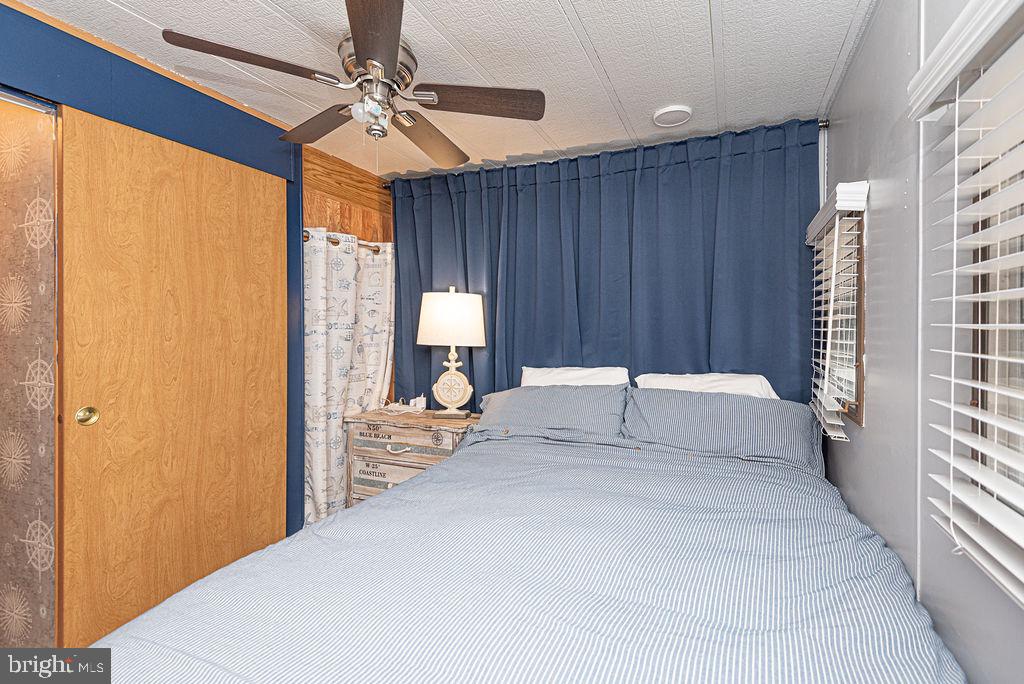 114 Skipjack Circle Berlin, MD 21811 - Photo 43 of 51 a view of a bedroom with a bed and a chandelier