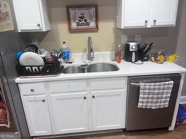 1035 South Barnett Shoals Road, Unit 913 Athens, GA 30605 - Photo 5 of 14 a kitchen with white cabinets and clock on the wall