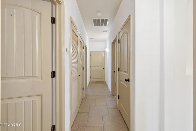 a view of a hallway with a wooden door