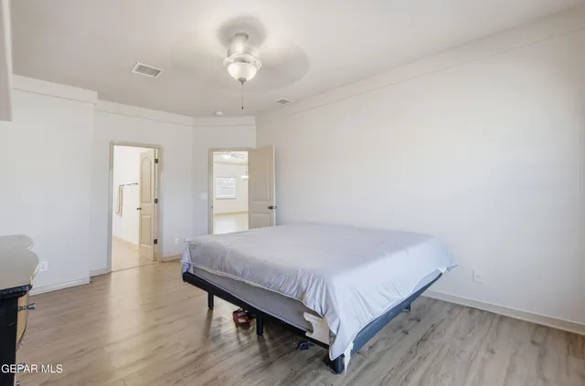 a bedroom with a bed and a chandelier