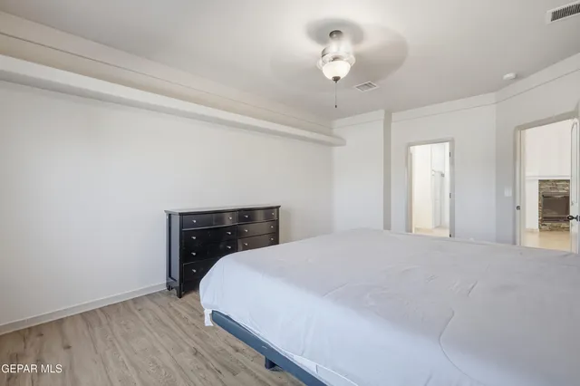 a spacious bedroom with a bed and a table in it