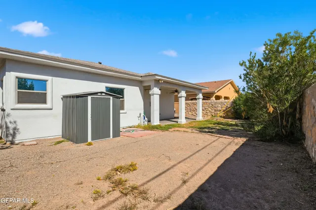 an aerial view of a house with a yard and potted plants