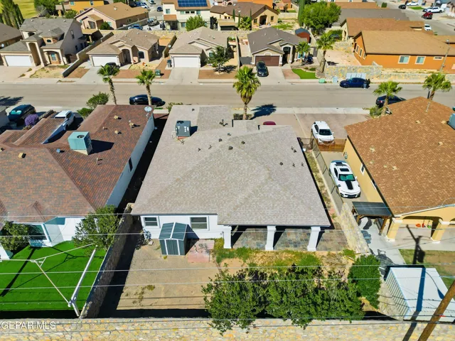 an aerial view of a house with a yard
