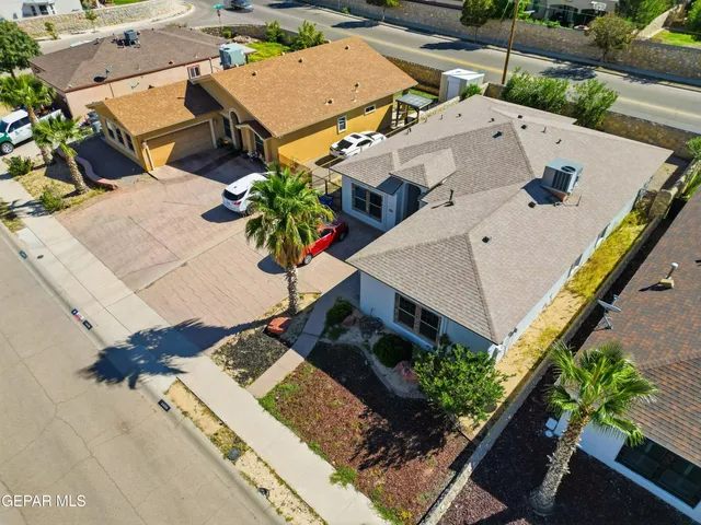 an aerial view of residential house with outdoor space and seating area