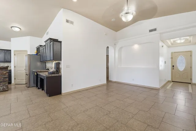 a view of a kitchen with a sink and refrigerator