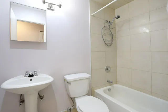 a bathroom with a toilet sink shower and mirror