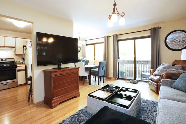 a living room with furniture a large window and a flat screen tv