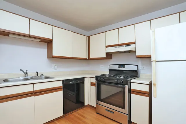 a kitchen with a sink a stove and refrigerator