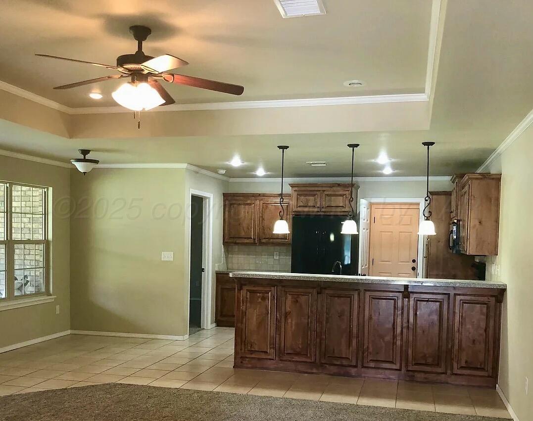 6809 Nick Street Amarillo, TX 79119 - Photo 4 of 13 a view of a kitchen with a sink and a chandelier fan
