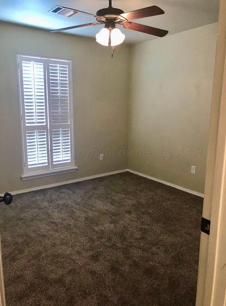 6809 Nick Street Amarillo, TX 79119 - Photo 8 of 13 an empty room with a window and a fan