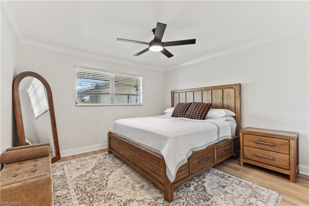 1020 Palm View Drive, Unit C302 Naples, FL 34110 - Photo 11 of 19 Bedroom featuring light wood-style flooring, a ceiling fan, and ornamental molding