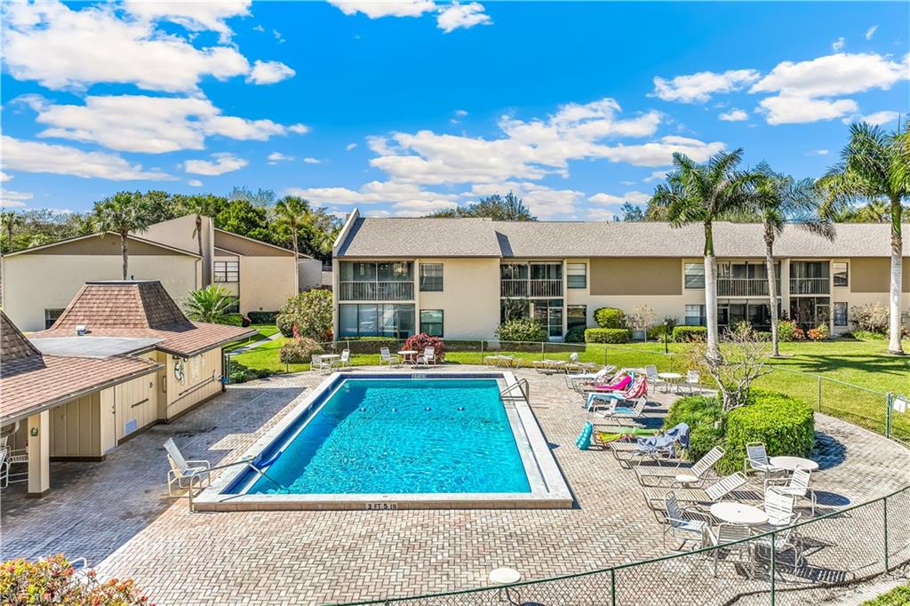 1020 Palm View Drive, Unit C302 Naples, FL 34110 - Photo 16 of 19 Community pool with a patio area
