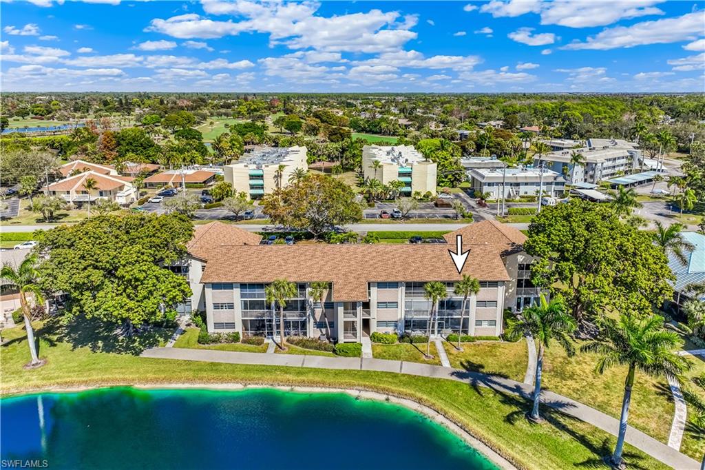 1020 Palm View Drive, Unit C302 Naples, FL 34110 - Photo 19 of 19 Aerial view of a large body of water and apartment complex