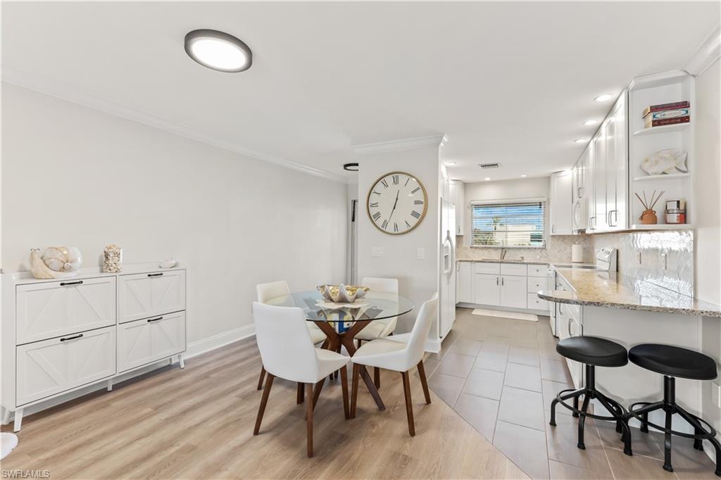 1020 Palm View Drive, Unit C302 Naples, FL 34110 - Photo 5 of 19 Dining room with crown molding and light wood-style flooring