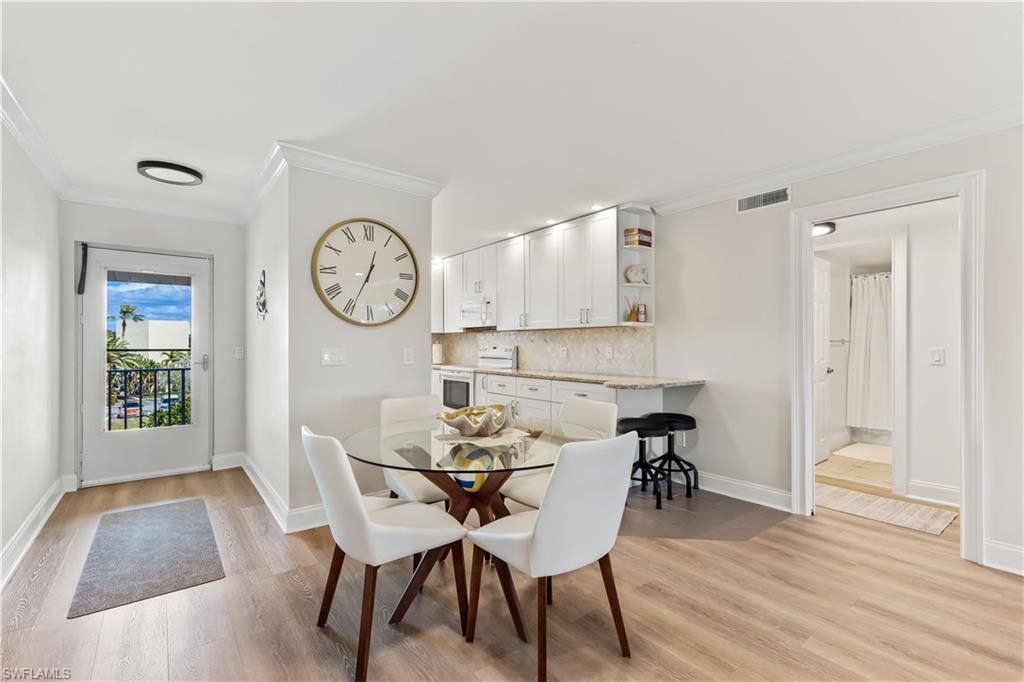 1020 Palm View Drive, Unit C302 Naples, FL 34110 - Photo 8 of 19 Dining space featuring ornamental molding and light wood-type flooring