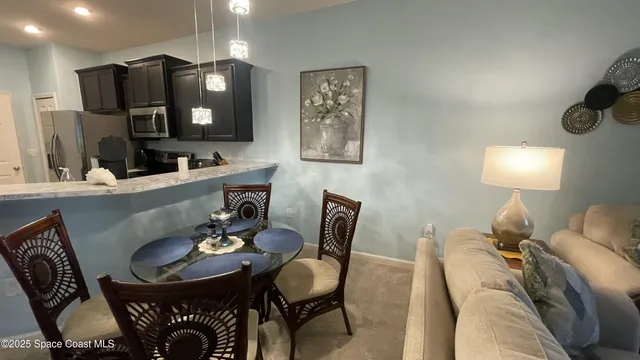 a living room with furniture a mirror and a lamp