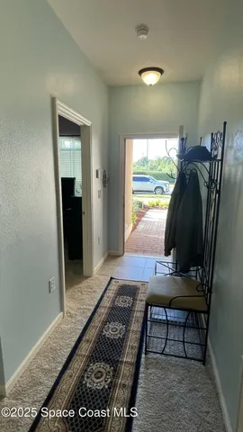 a living room with furniture rug and a window