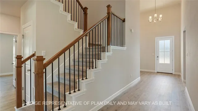 a view of staircase with railing and white walls