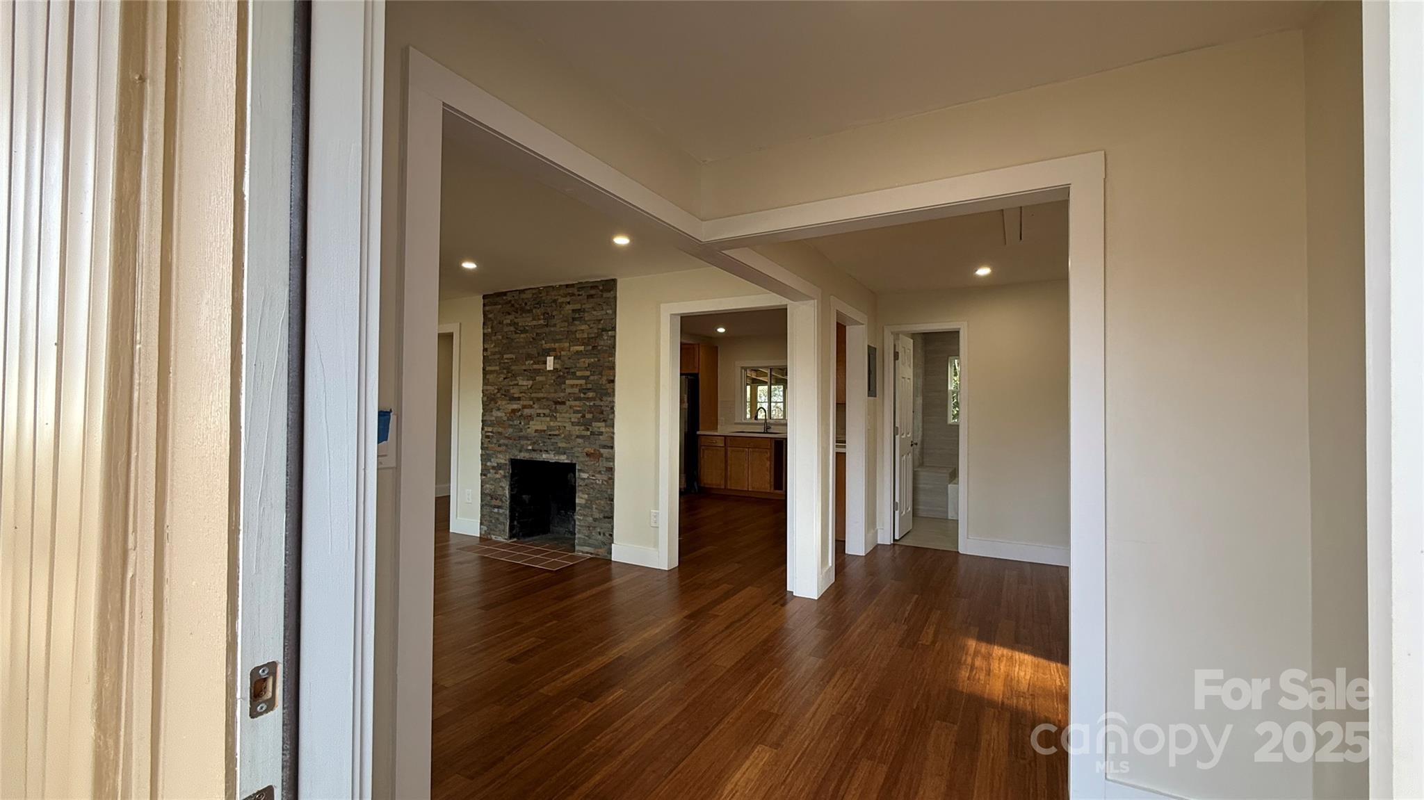 809 Howard Street Shelby, NC 28152 - Photo 16 of 41 a view of a hallway with wooden floor and staircase