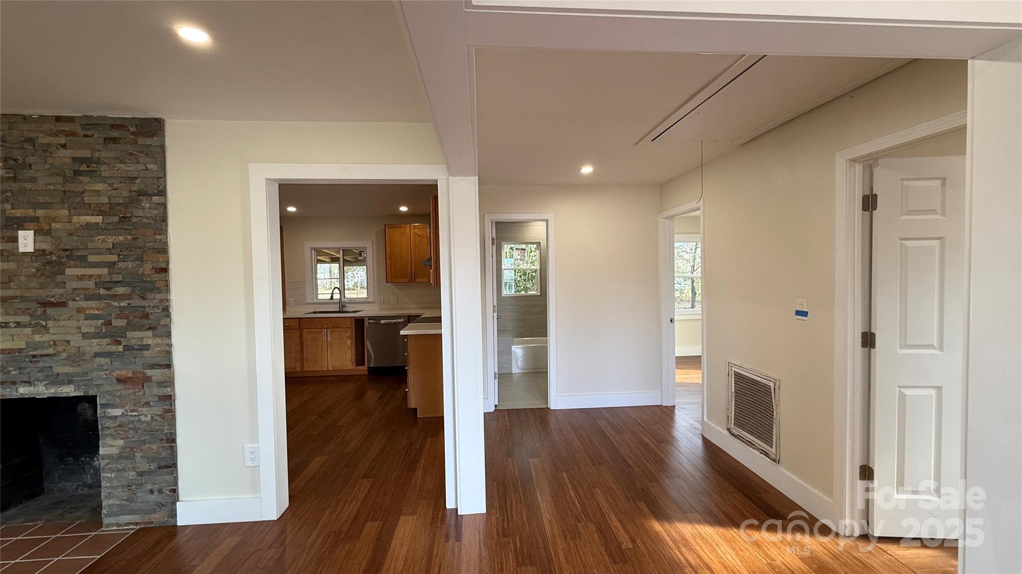 809 Howard Street Shelby, NC 28152 - Photo 17 of 41 a view of a hallway with wooden floor and a kitchen