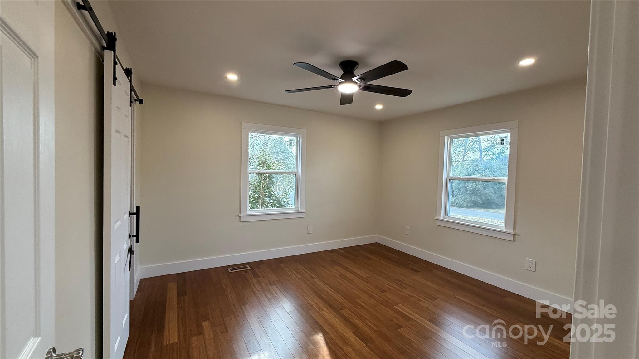 809 Howard Street Shelby, NC 28152 - Photo 19 of 41 a view of an empty room with wooden floor and a window