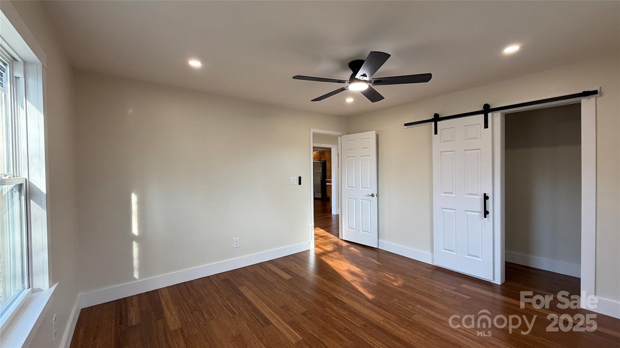 809 Howard Street Shelby, NC 28152 - Photo 20 of 41 a view of empty room with wooden floor and fan