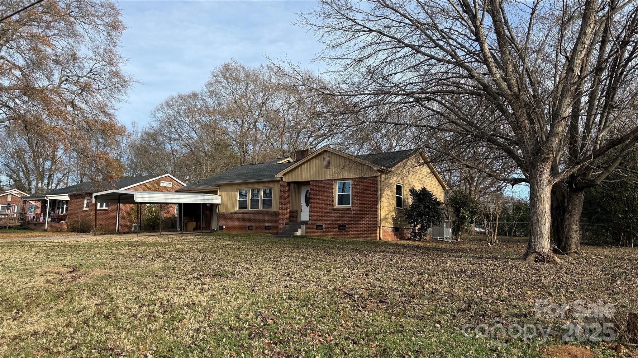 809 Howard Street Shelby, NC 28152 - Photo 2 of 41 a front view of a house with a yard and large trees