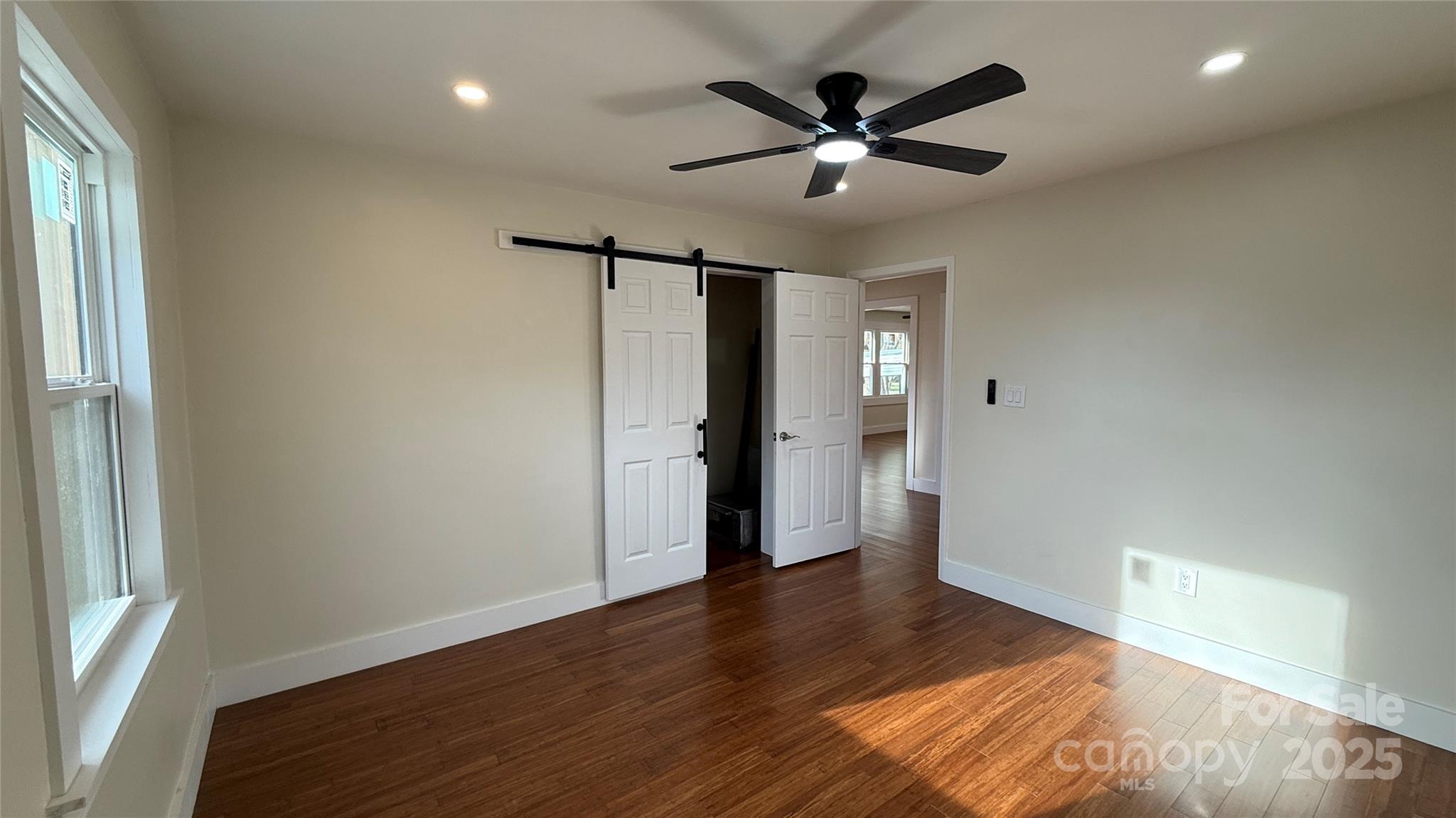 809 Howard Street Shelby, NC 28152 - Photo 23 of 41 an empty room with wooden floor and windows