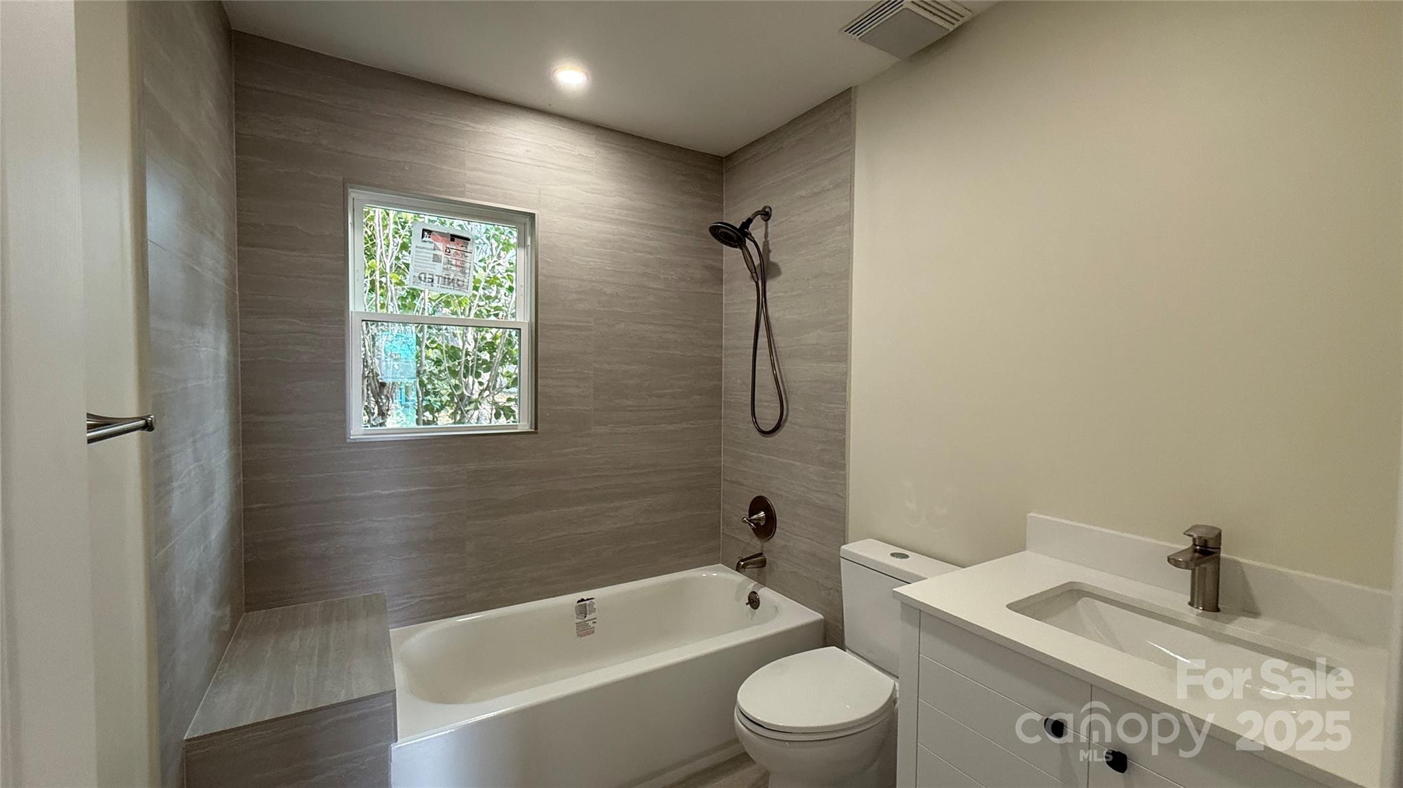 809 Howard Street Shelby, NC 28152 - Photo 24 of 41 a bathroom with a granite countertop bathtub sink vanity mirror and toilet