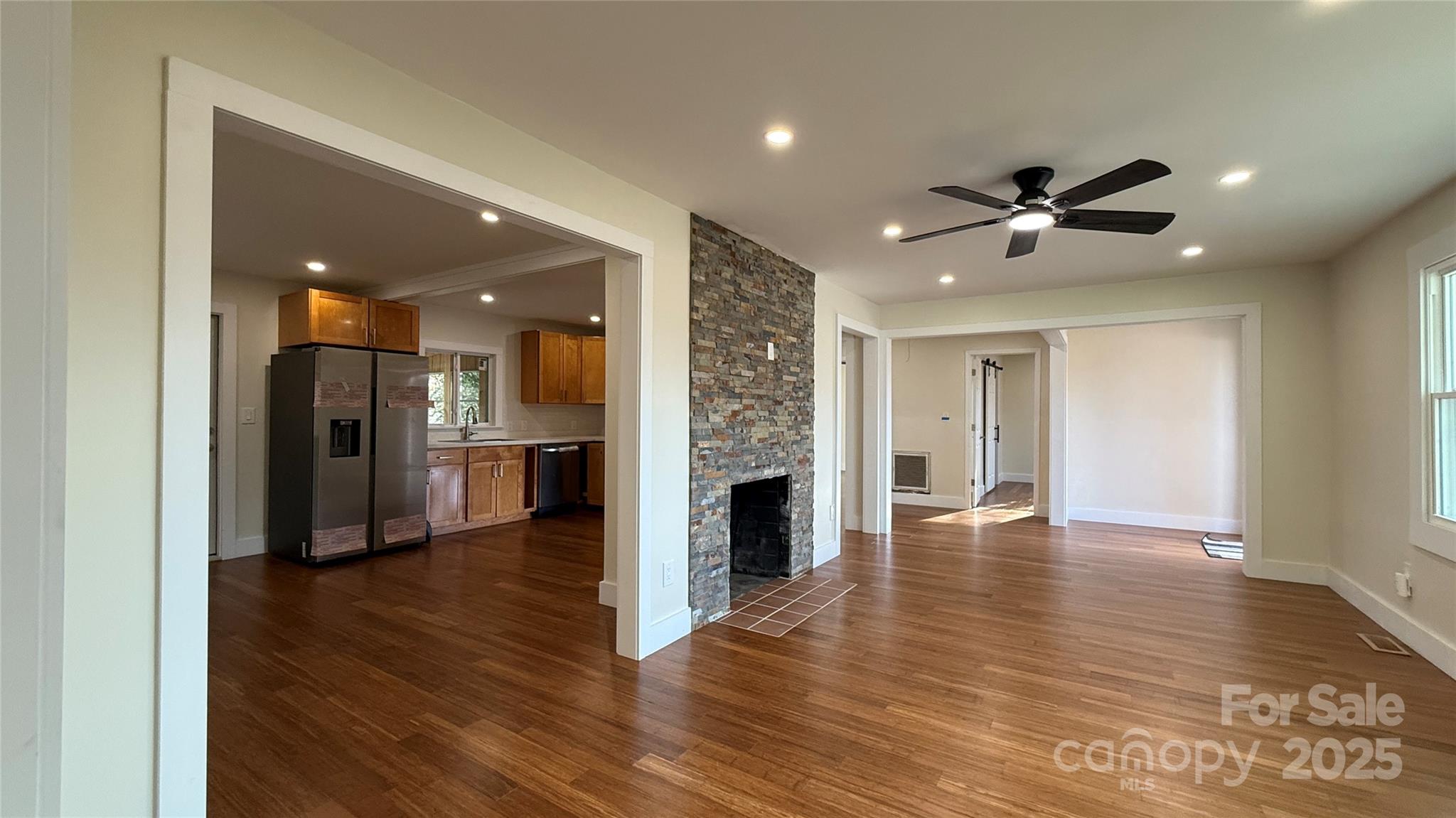 809 Howard Street Shelby, NC 28152 - Photo 29 of 41 a view of a big room with wooden floor and a kitchen