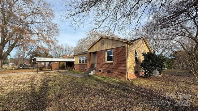 a view of a house with a yard covered in snow