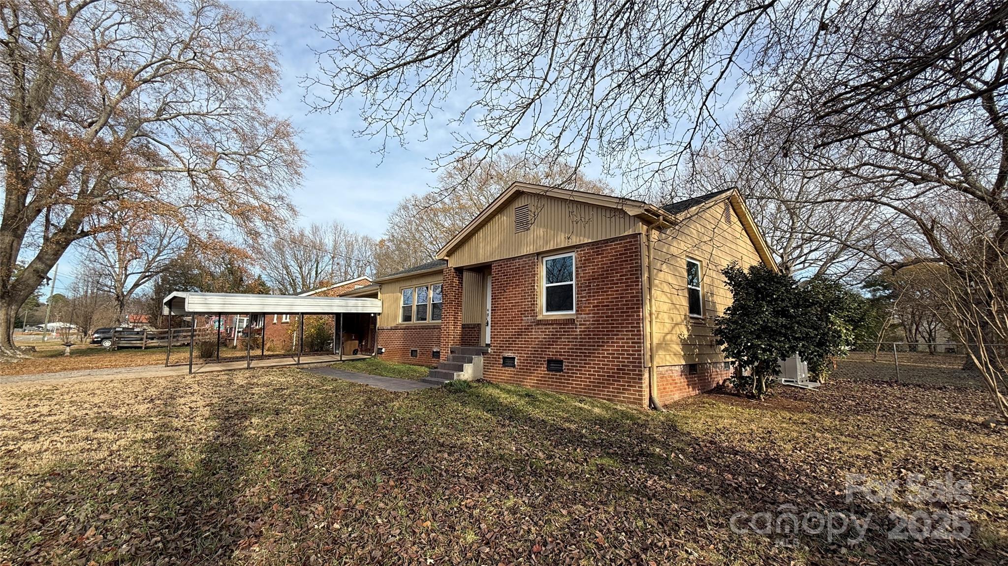809 Howard Street Shelby, NC 28152 - Photo 3 of 41 a view of a house with a yard covered in snow