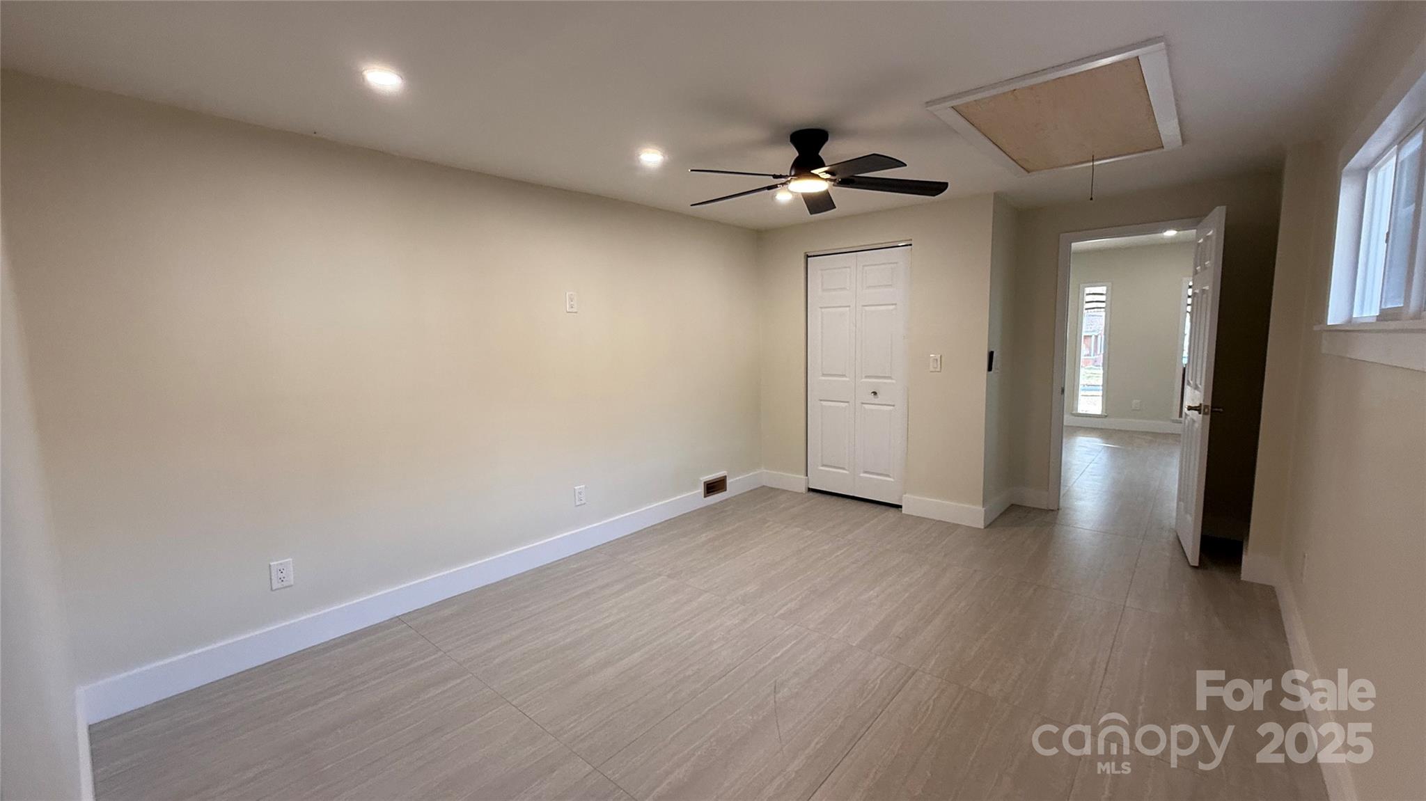 809 Howard Street Shelby, NC 28152 - Photo 37 of 41 an empty room with wooden floor and a ceiling fan