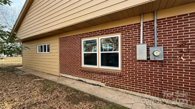 a backyard of a house with table and chairs