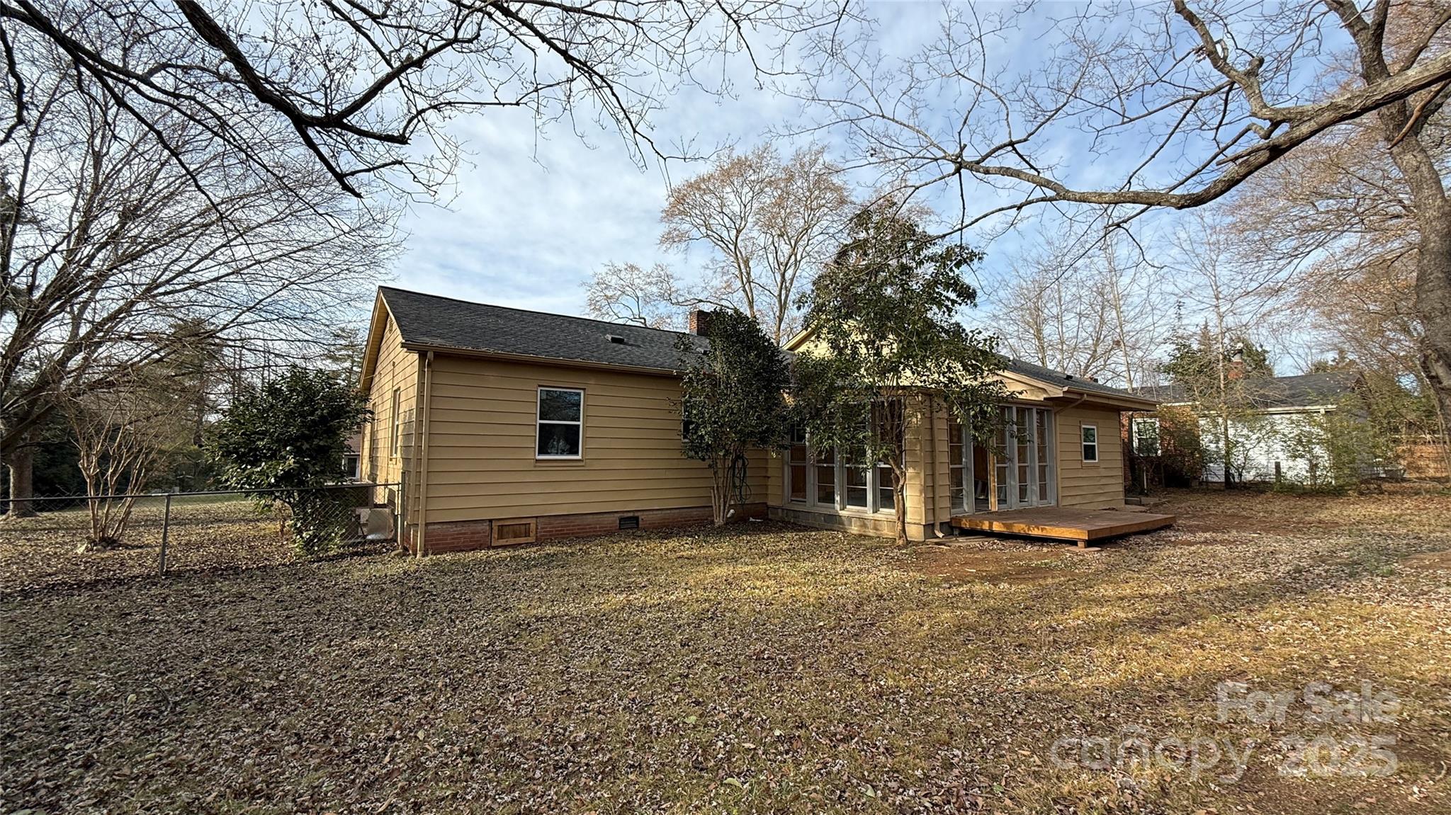 809 Howard Street Shelby, NC 28152 - Photo 9 of 41 a backyard of a house with large trees and a barn