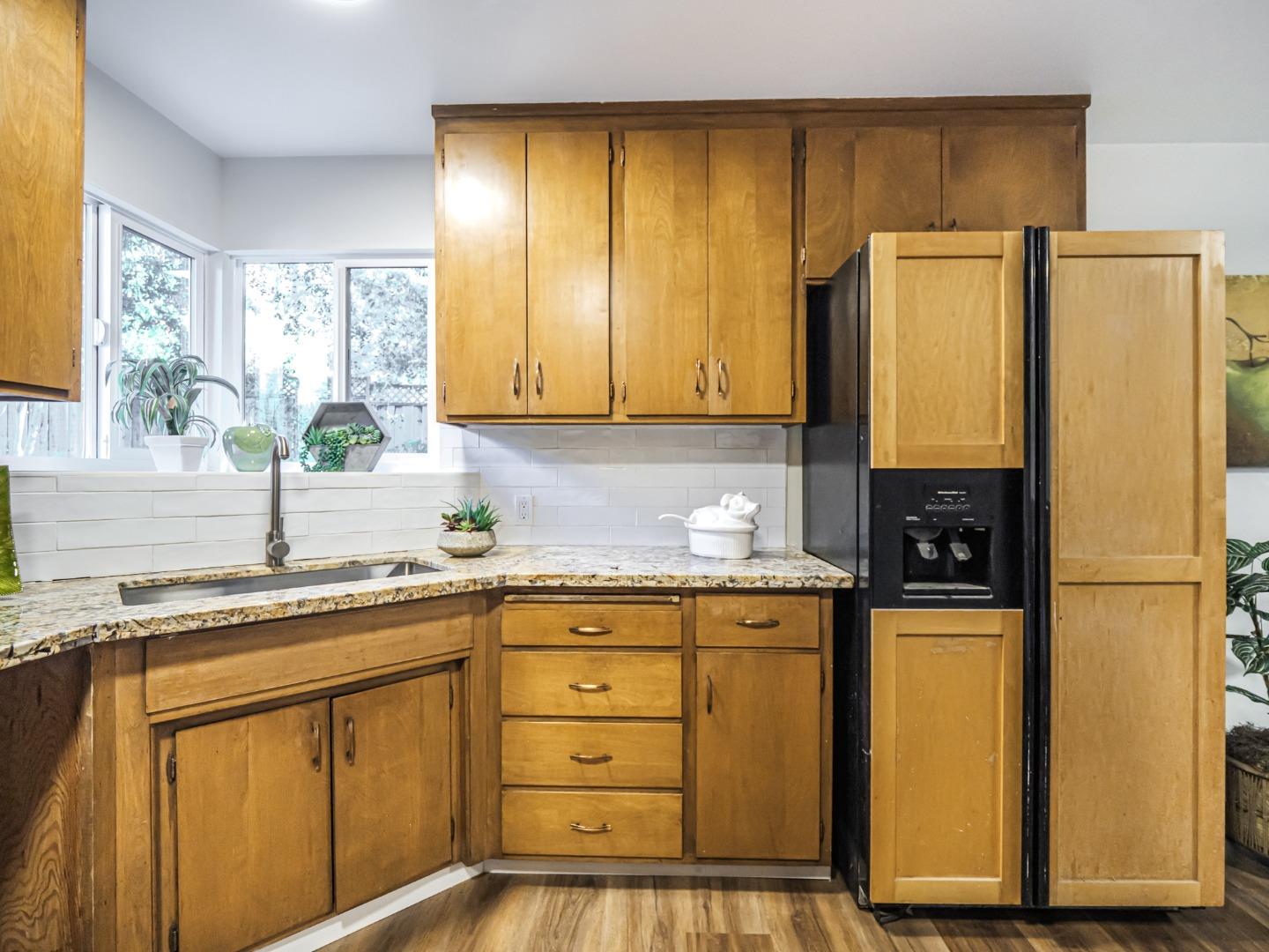 8460 Hihn Road Ben Lomond, CA 95005 - Photo 14 of 50 a kitchen with stainless steel appliances granite countertop a refrigerator a sink and white cabinets