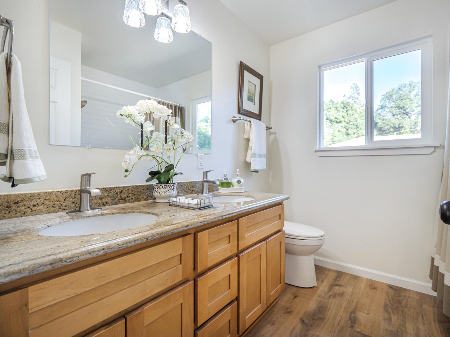8460 Hihn Road Ben Lomond, CA 95005 - Photo 31 of 50 a bathroom with a granite countertop sink a toilet and a mirror