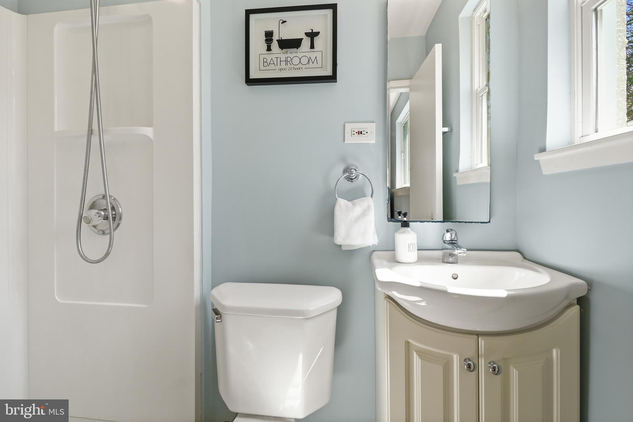 8600 Grubb Road Chevy Chase, MD 20815 - Photo 18 of 36 a bathroom with a toilet sink and mirror