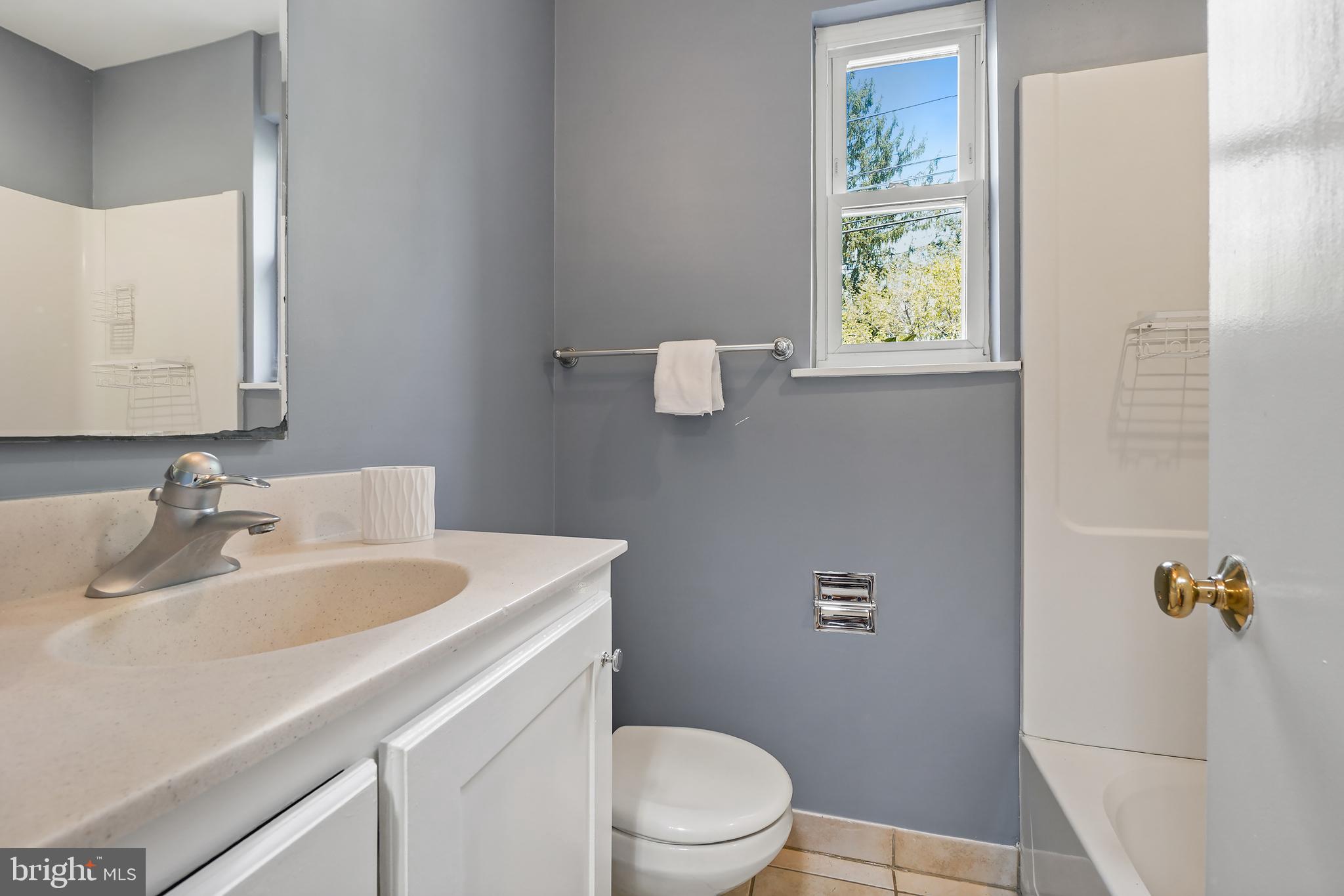 8600 Grubb Road Chevy Chase, MD 20815 - Photo 20 of 36 a bathroom with a sink a toilet and a mirror