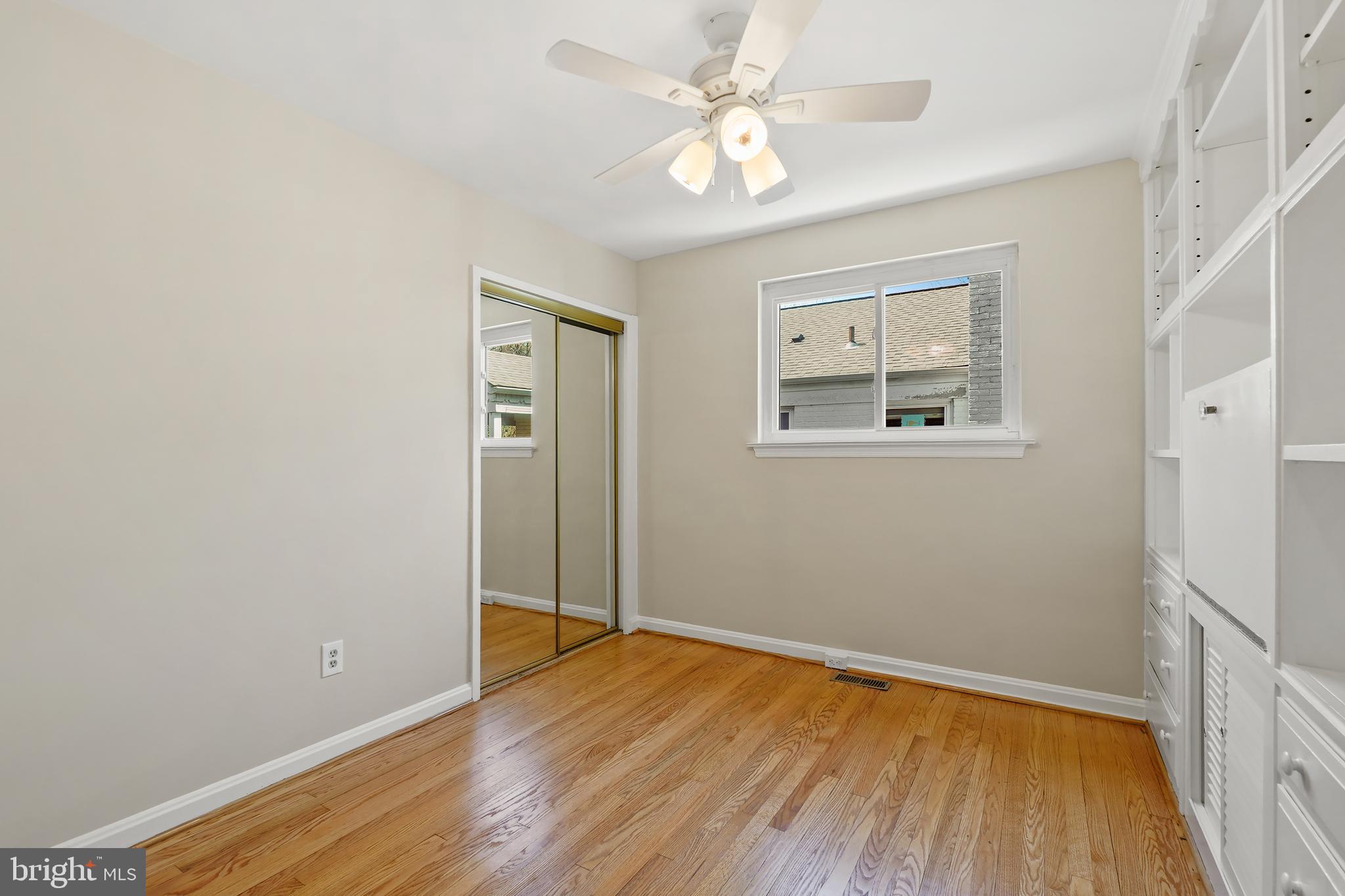 8600 Grubb Road Chevy Chase, MD 20815 - Photo 21 of 36 wooden floor in an empty room with a window