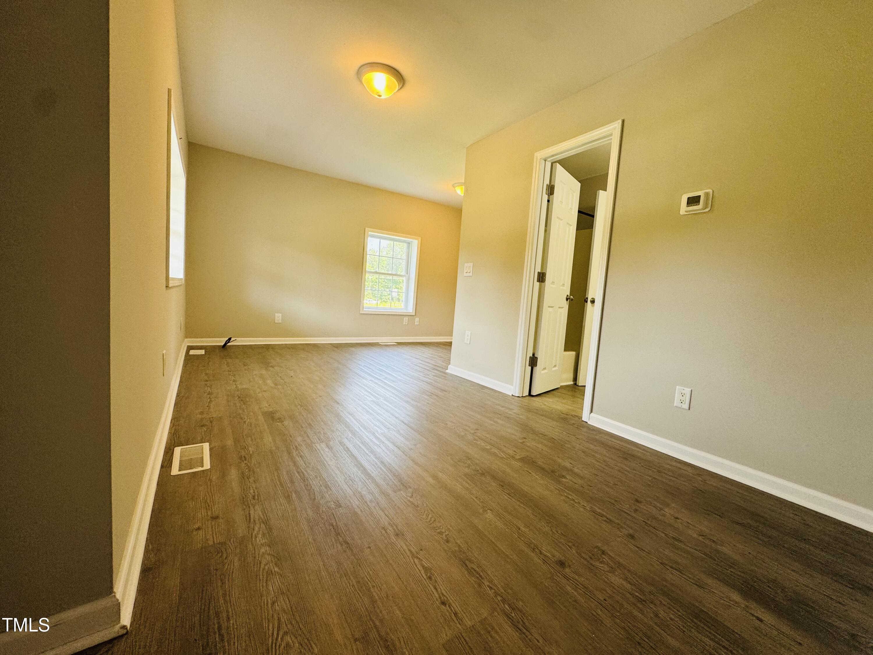 527 Forrest Street Hillsborough, NC 27278 - Photo 11 of 44 a view of a room with wooden floor and a window