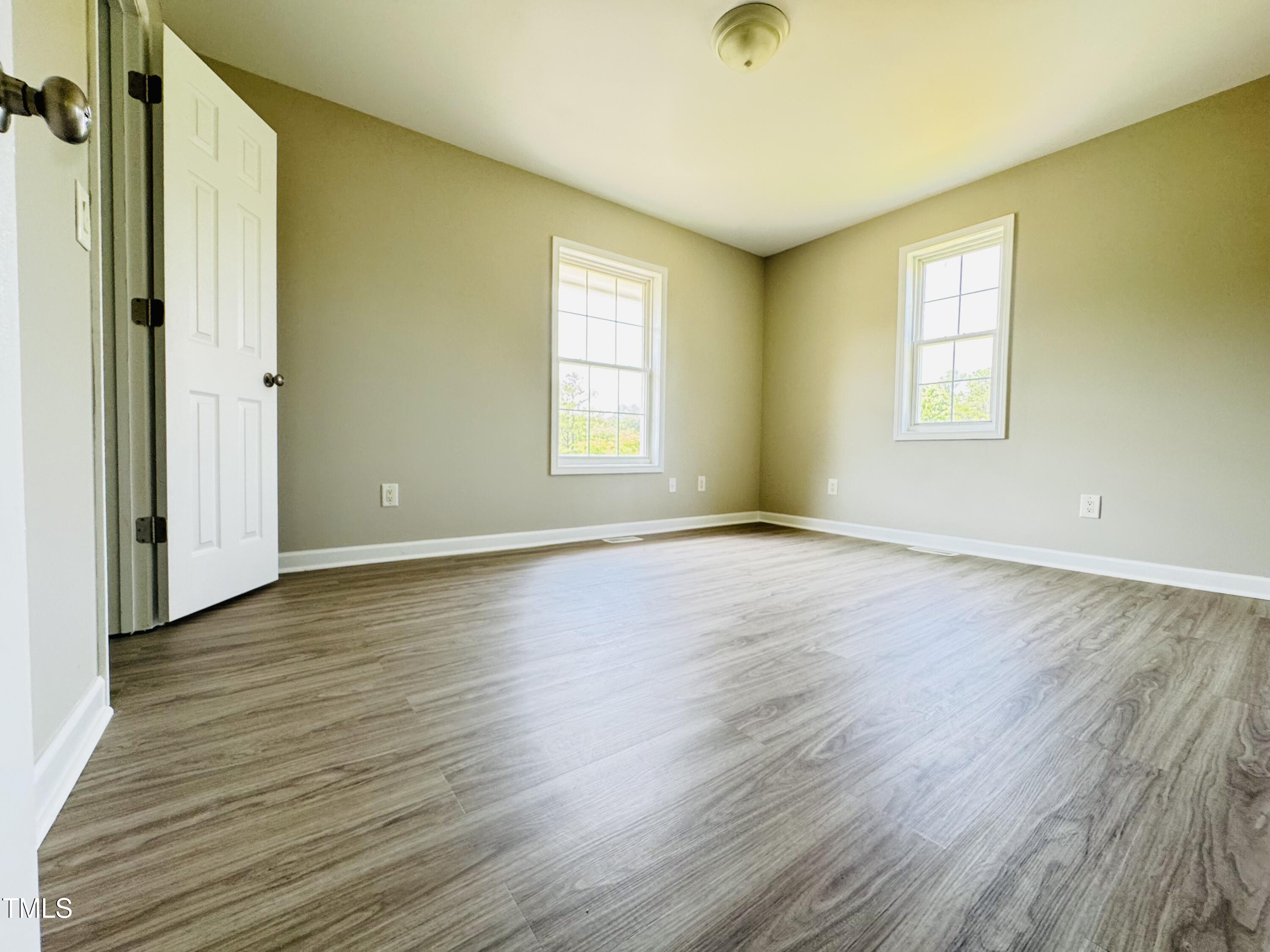 527 Forrest Street Hillsborough, NC 27278 - Photo 20 of 44 an empty room with wooden floor and windows