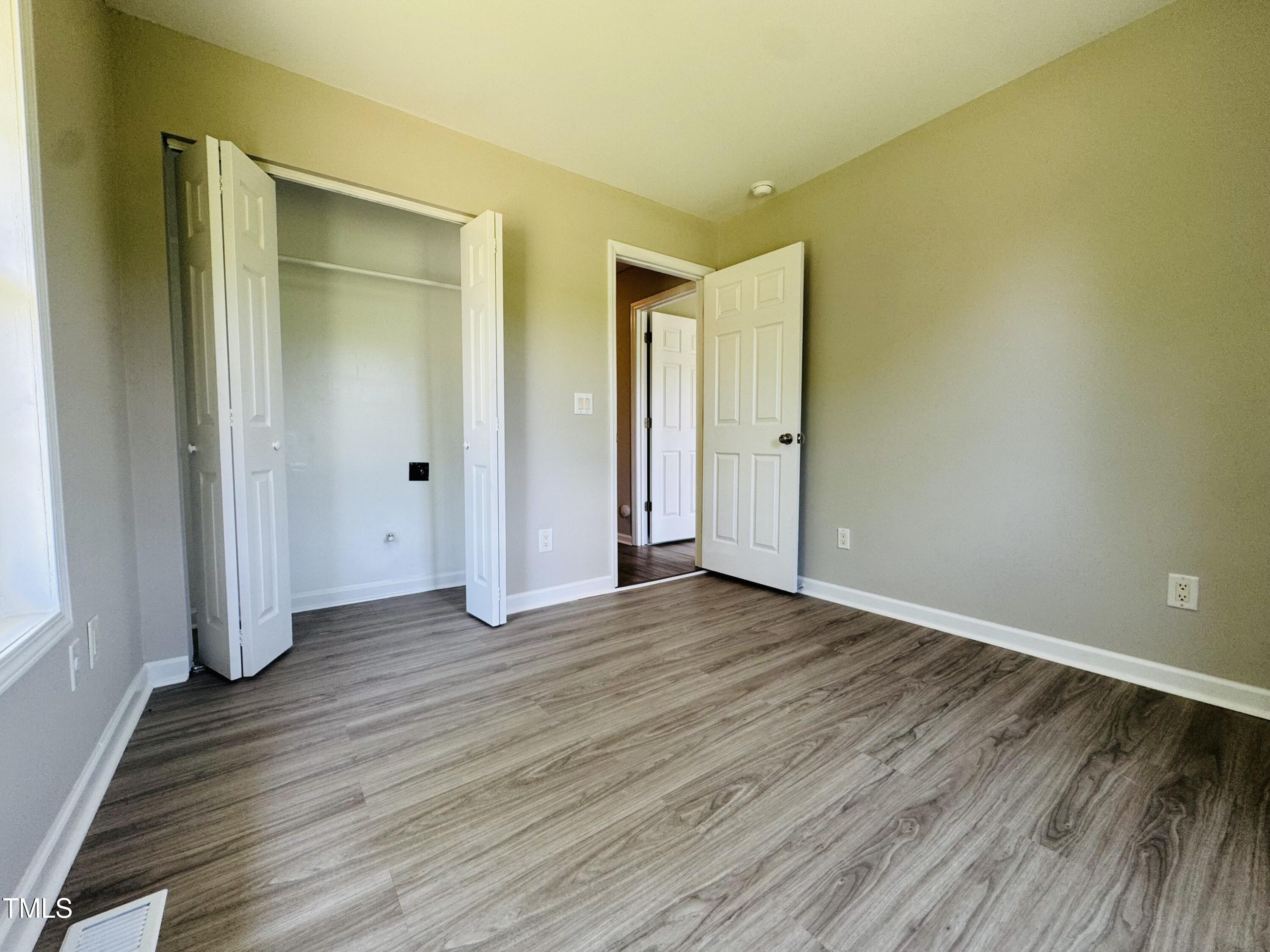 527 Forrest Street Hillsborough, NC 27278 - Photo 22 of 44 an empty room with wooden floor and closet