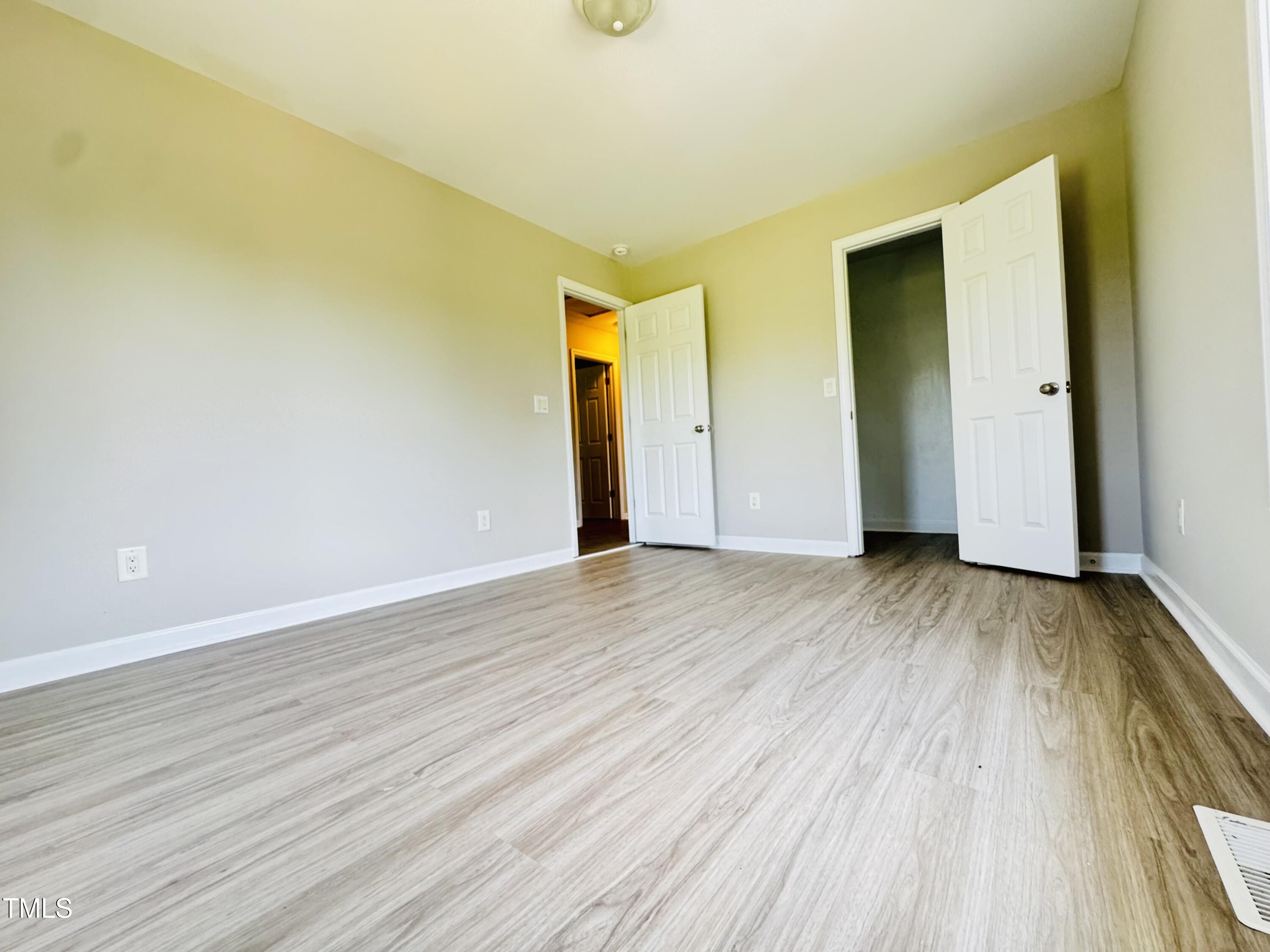 527 Forrest Street Hillsborough, NC 27278 - Photo 23 of 44 a view of an empty room with wooden floor and a window
