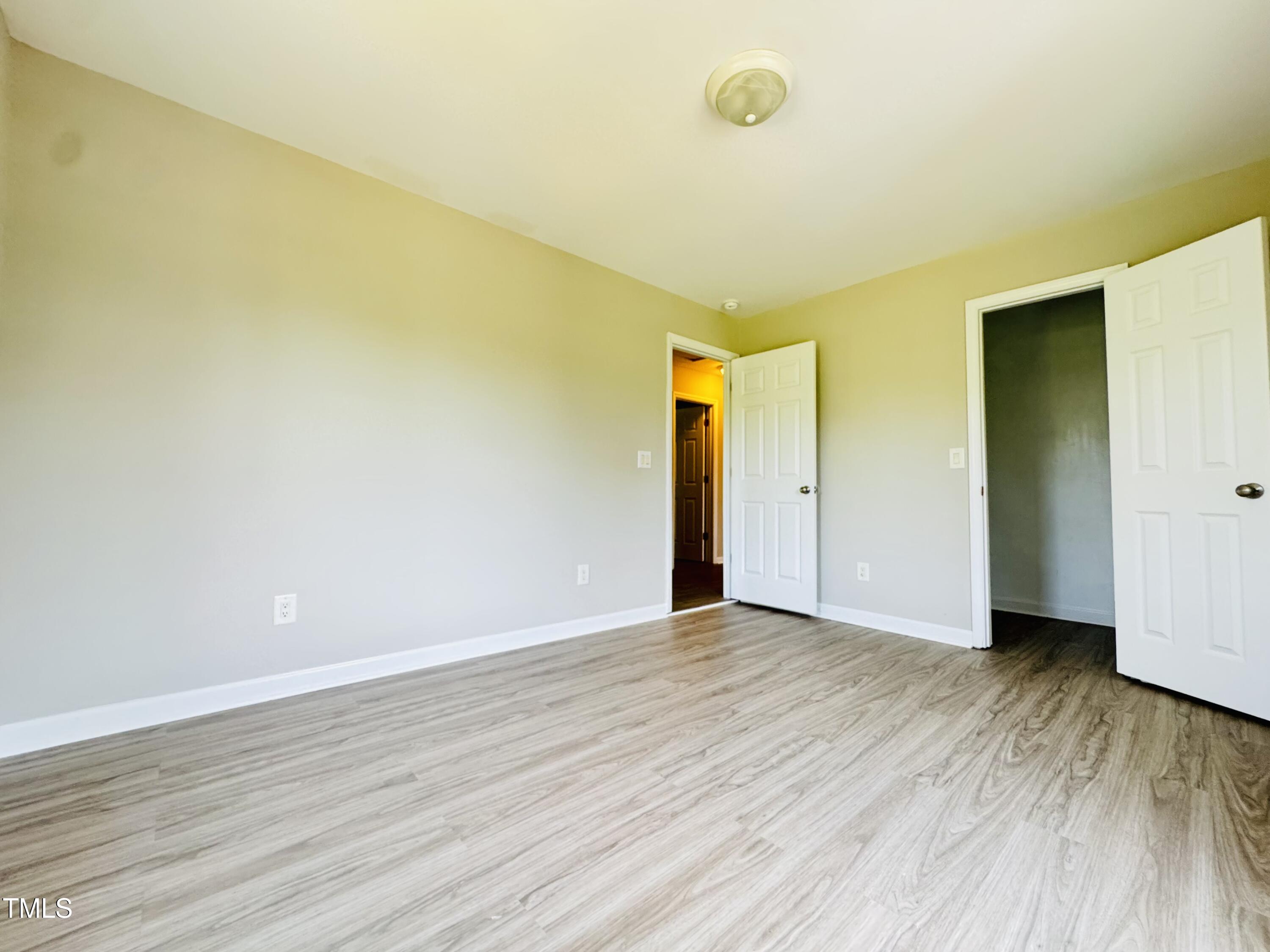 527 Forrest Street Hillsborough, NC 27278 - Photo 25 of 44 a view of an empty room with wooden floor