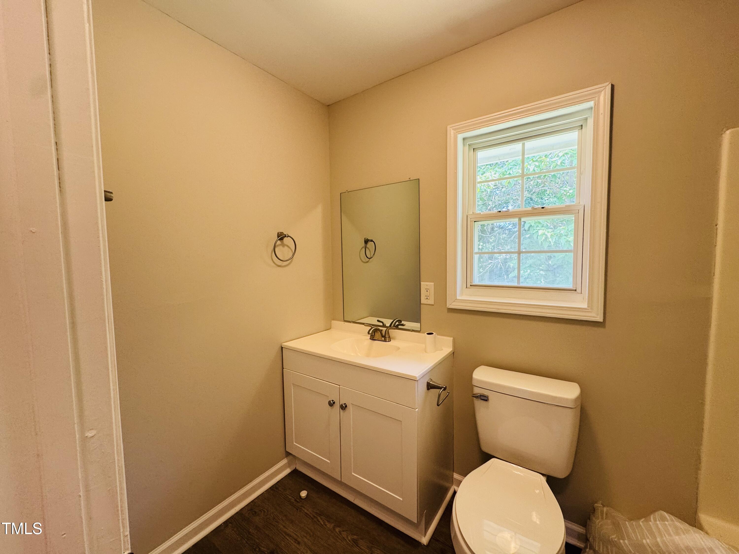 527 Forrest Street Hillsborough, NC 27278 - Photo 27 of 44 a bathroom with a toilet sink vanity and mirror