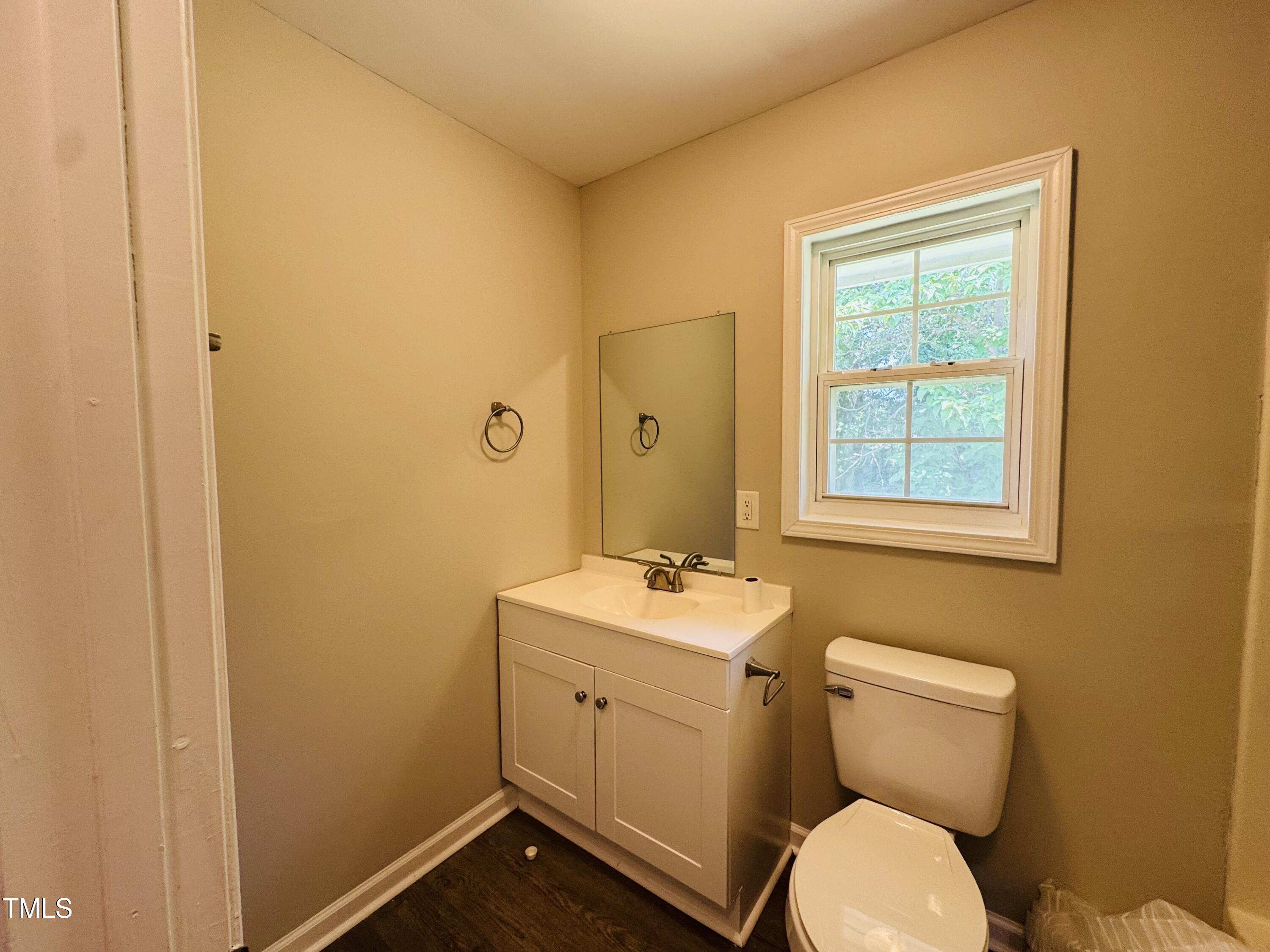 527 Forrest Street Hillsborough, NC 27278 - Photo 28 of 44 a bathroom with a toilet sink vanity and mirror